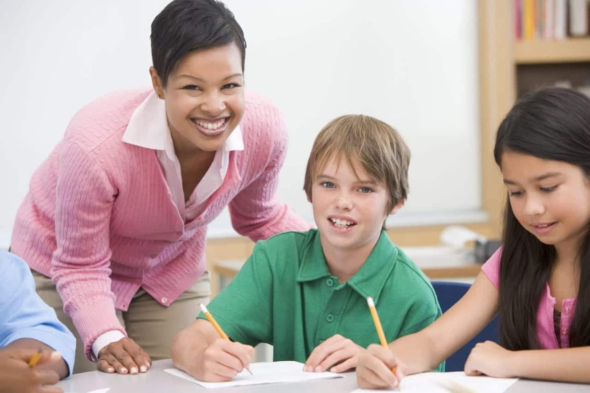 teacher and students working on a project