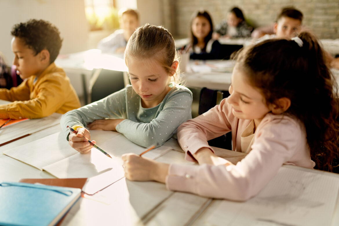 2 girls working together in classroom