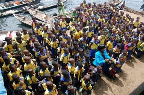 1. Betty Abah, CEE-HOPE's founder (in front) with pupils in a school in Makoko, Lagos