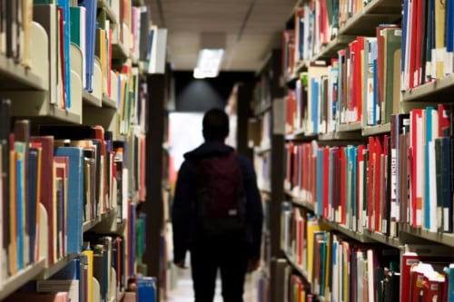 student in library