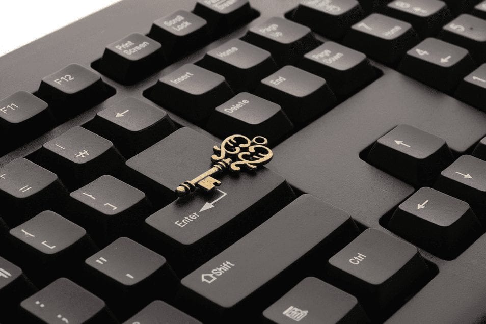 old-time gold key sitting on the enter button on a computer keyboard