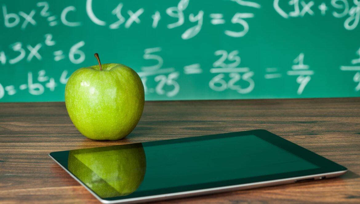 Digital tablet and apple on the desk