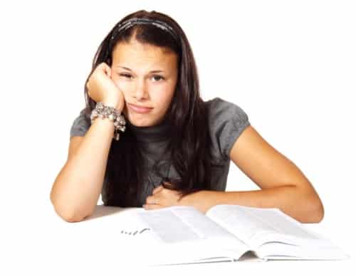 Bored female student with textbook