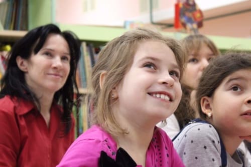 child smiling at teacher