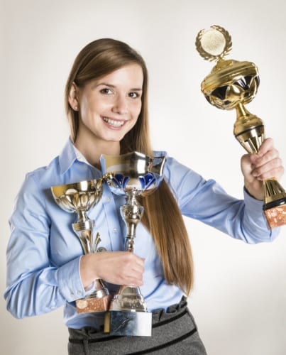 student with trophies