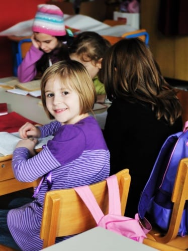 Bright girl in a group at school