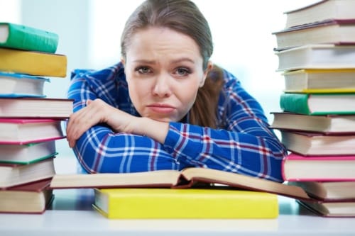 frustrated teacher surrounded by books