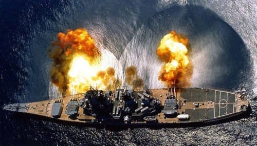 July 1, 1984: USS Iowa fires a full broadside of nine 16"/50 and six 5"/38 guns during a target exercise near Vieques Island, Puerto Rico. Note concussion effects on the water surface, and 16-inch gun barrels in varying degrees of recoil.