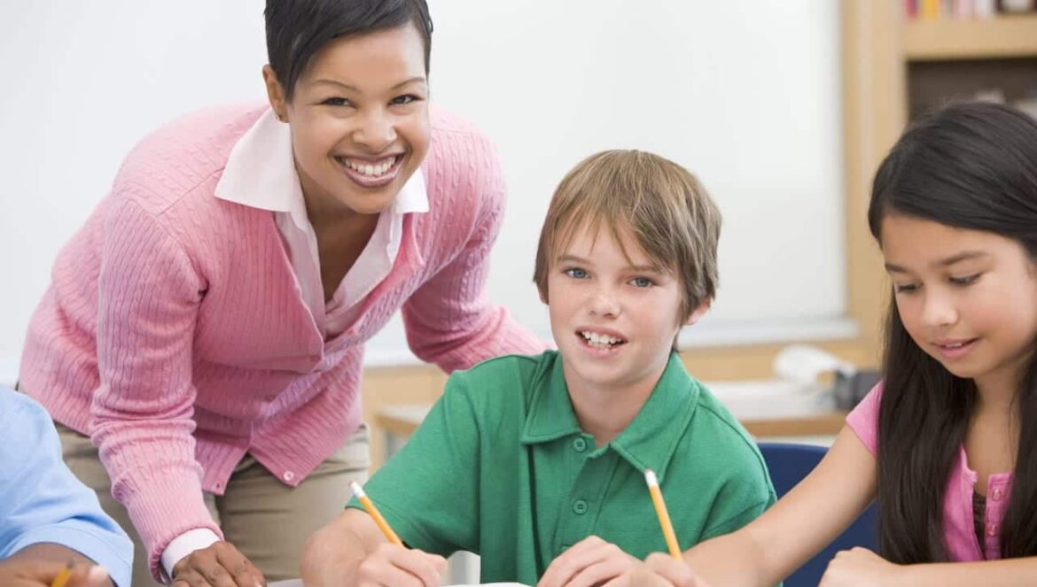 teacher and students working on a project