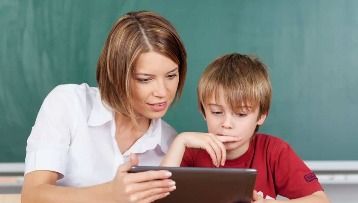 Teacher and student looking at a tablet