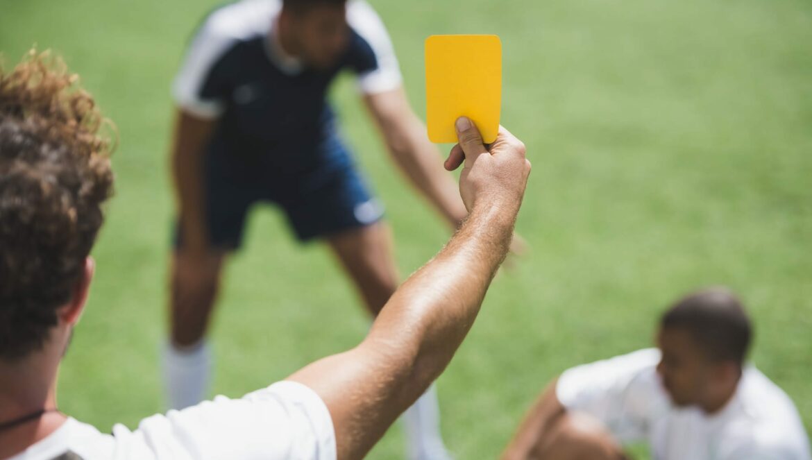 referee showing yellow card