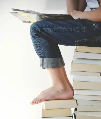 sitting on books