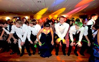 NEWCASTLE, UNITED KINGDOM - JULY 01: Students perform dance routines to the song "Macarena" on the dancefloor at St James' Park on July 1, 2011 in Newcastle, United Kingdom. After months of preparation more than 200 final year students aged 15 to 16 from Cramlington Learning Village attended a leaver's prom at St James Park, Newcastle. The prom marks the end of GCSE examinations and the completion of their high school studies. (Photo by Bethany Clarke/Getty Images)
