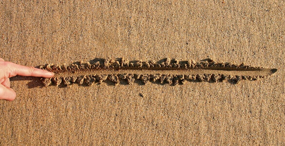 line in sand with finger