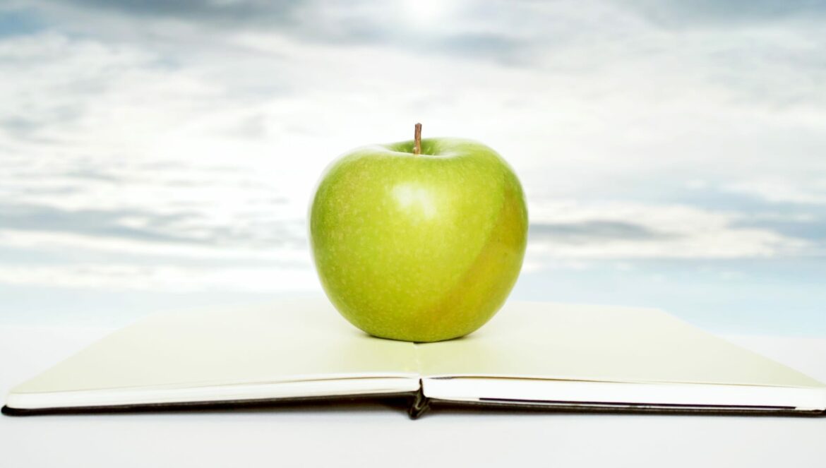 open book apple and sky