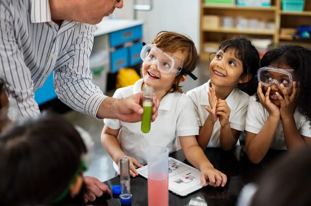 happy elementary kids doing a science experiment