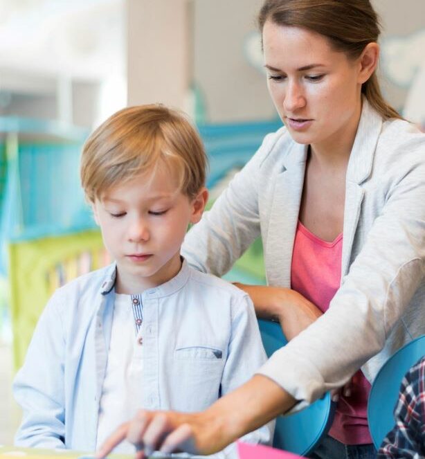 teacher helping boy