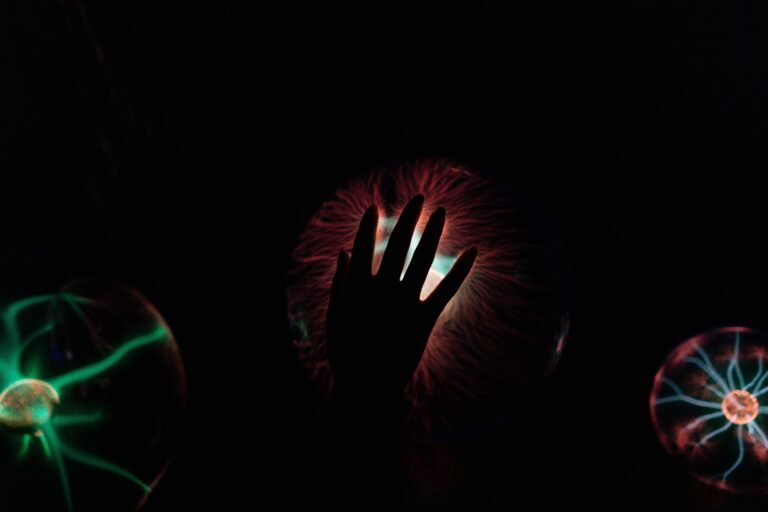 Silhouette of a hand interacting with a glowing plasma ball, illustrat