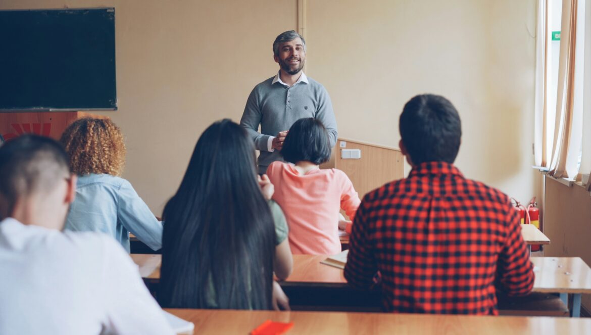 Teacher lecturing students in a classroom setting