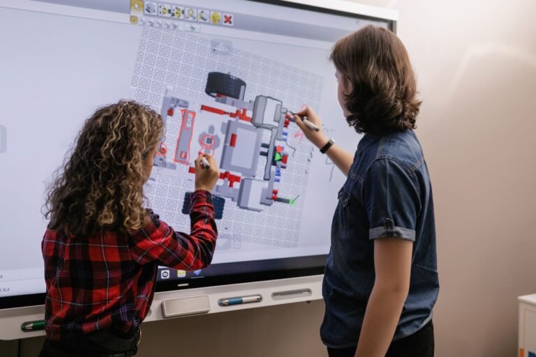 Two children working together at an interactive smart board in a modern classroom