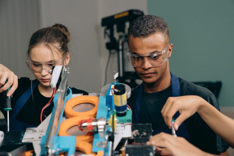 Two young engineers focusing on a robotics project indoors, showcasing