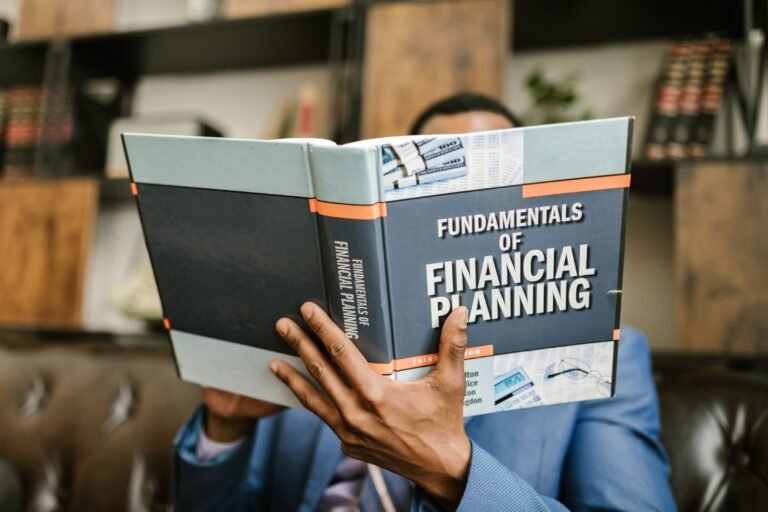 A professional individual in a suit reading 'Fundamentals of Financial