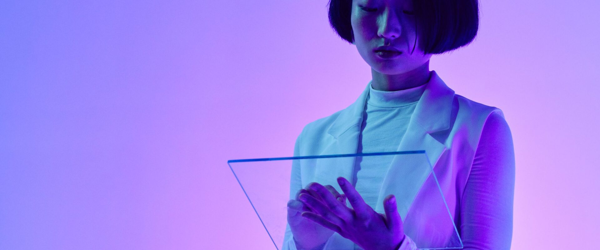 Woman interacts with a transparent digital screen in vibrant studio li