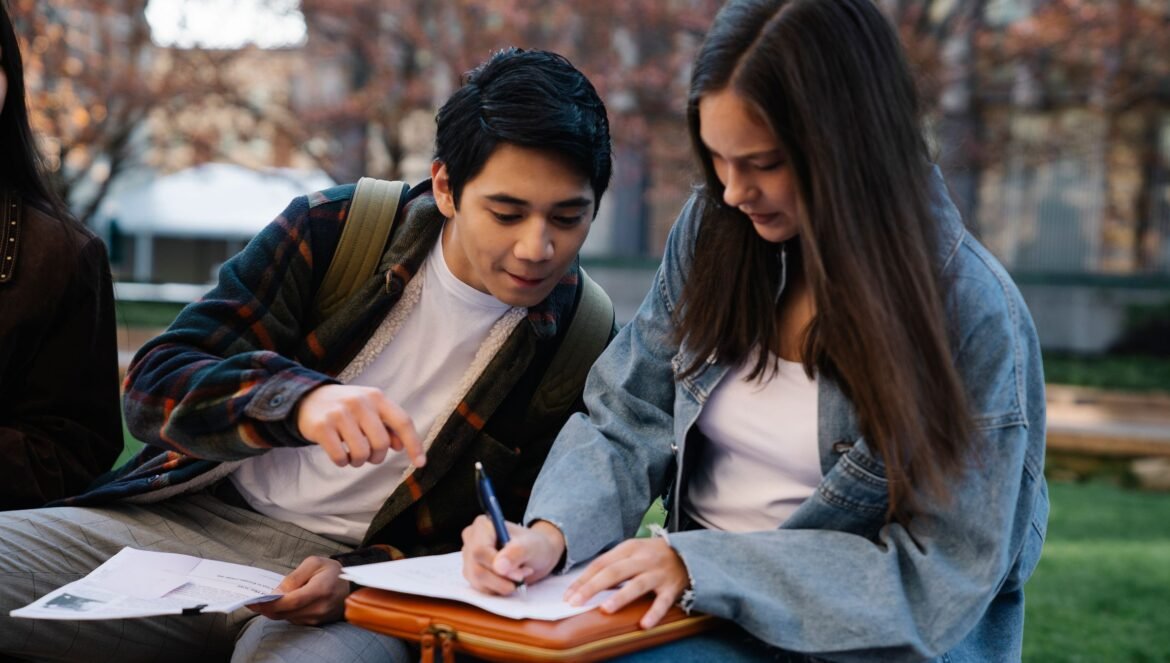 Two students working together on a study project outdoors