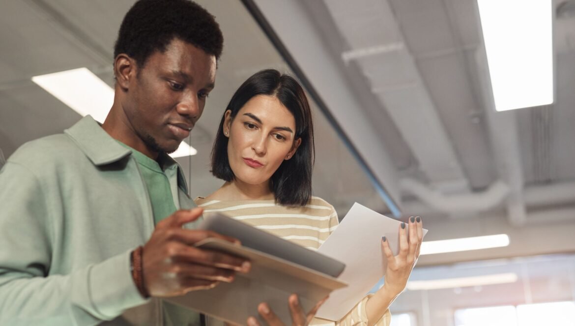 Two professionals collaborating on a project using a digital tablet in