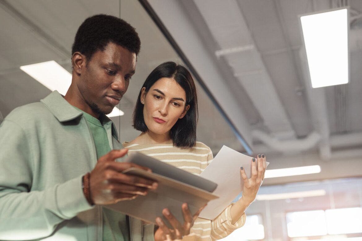 Two professionals collaborating on a project using a digital tablet in