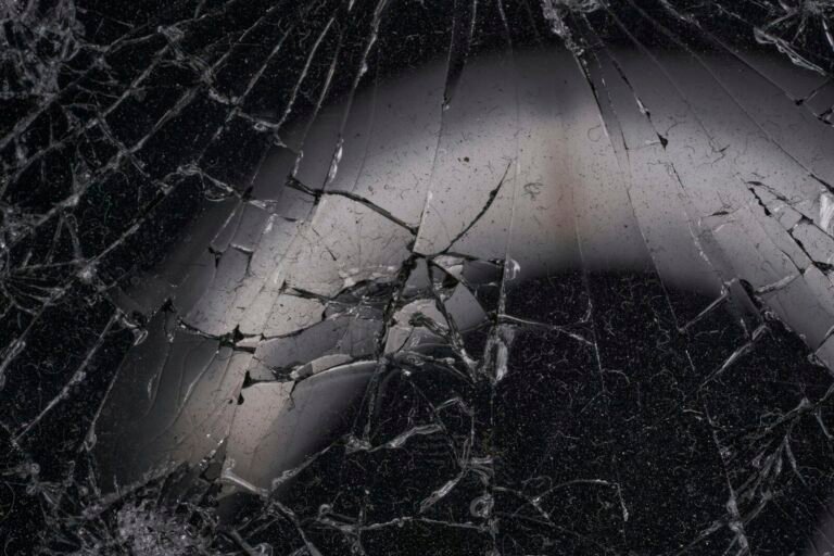 A black and white photo of a cracked window