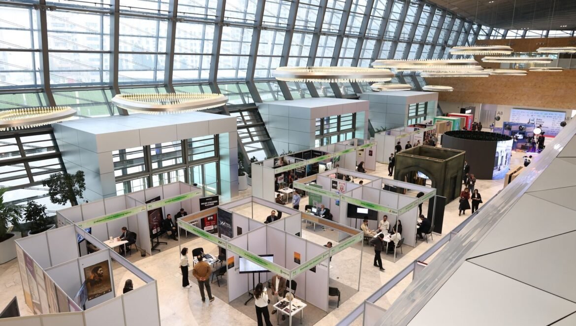 A bustling trade show exhibition inside a modern hall with people netw