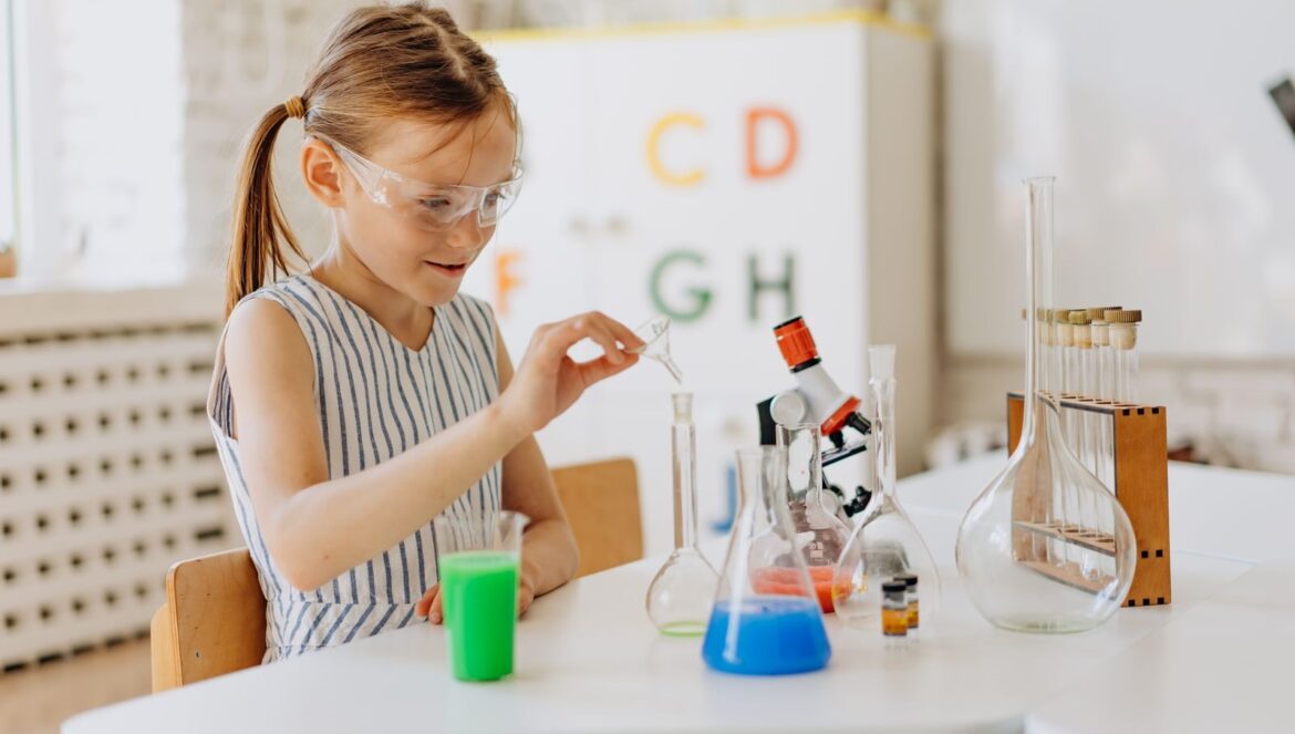 A girl performing science experiments with lab equipment showcasing l | edCircuit A girl performing science experiments with lab equipment showcasing l