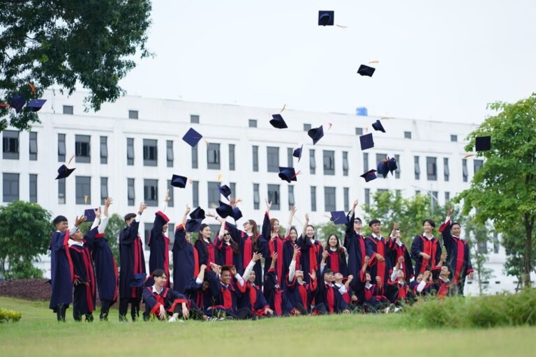 A group of graduates in Vietnam celebrate by throwing caps into the ai