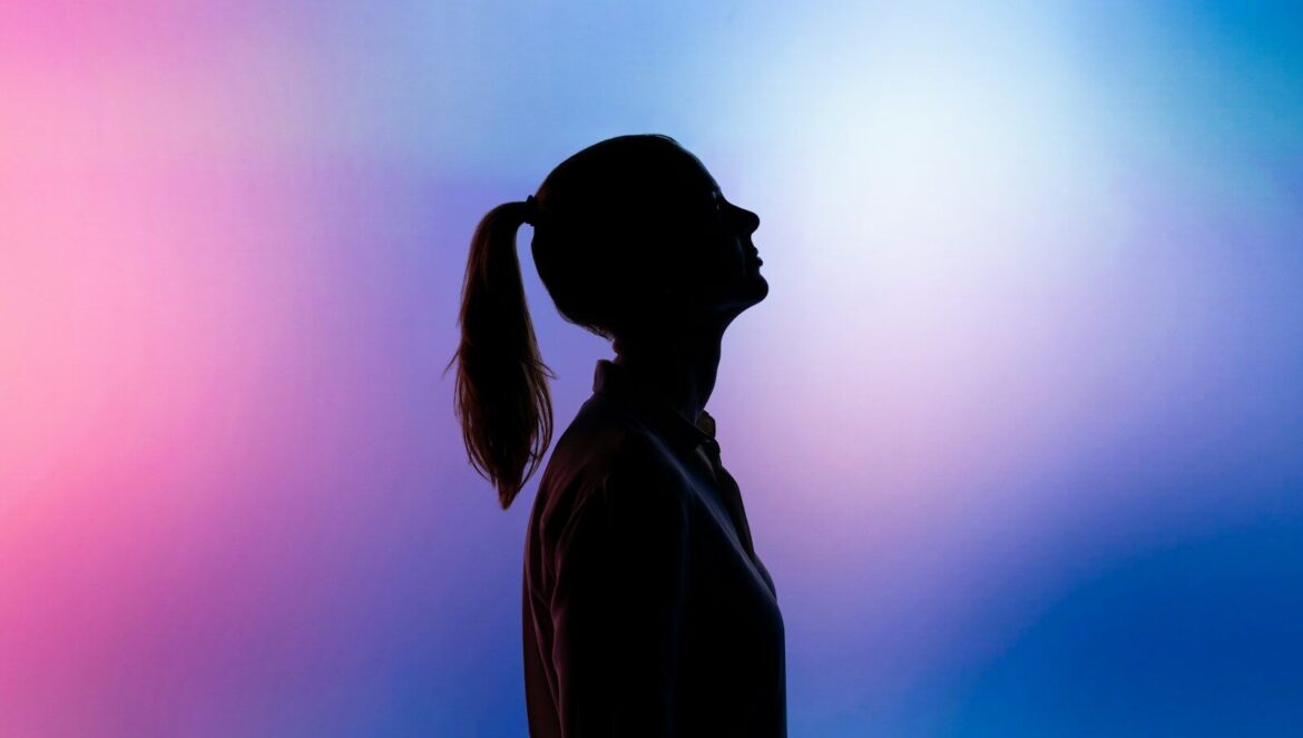 A silhouette of a woman with a ponytail against a pink and blue backgr | edCircuit A silhouette of a woman with a ponytail against a pink and blue backgr