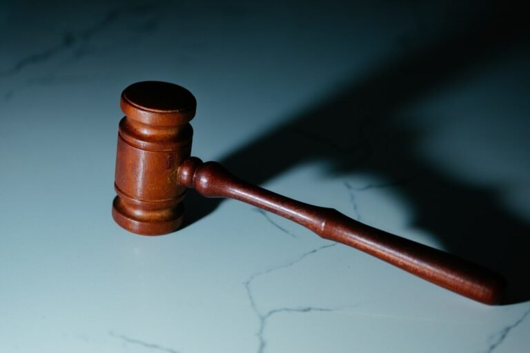 A wooden judge's hammer sitting on top of a table
