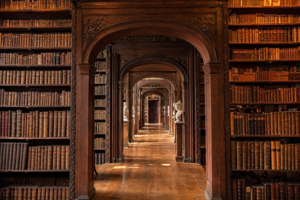 An ancient library interior with classic wooden arches and towering bookfilled shelves warm light | edCircuit An ancient library interior with classic wooden arches and towering book filled shelves warm light