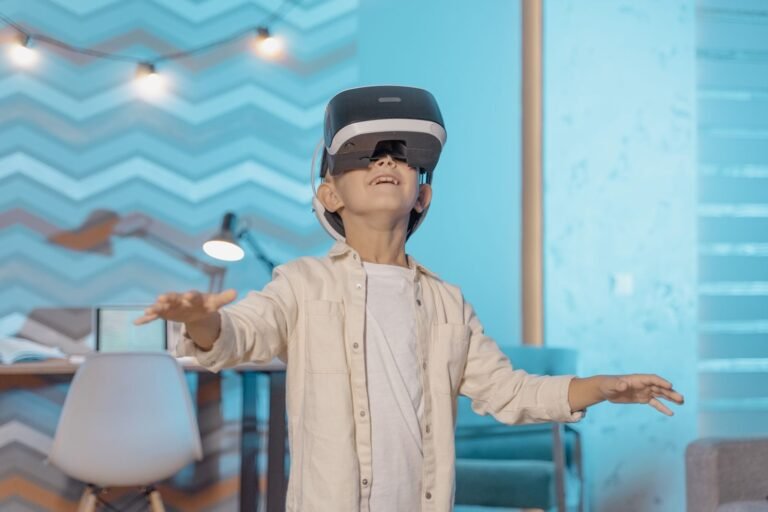 Boy wearing VR goggles experiencing virtual reality indoors with a joyful expression
