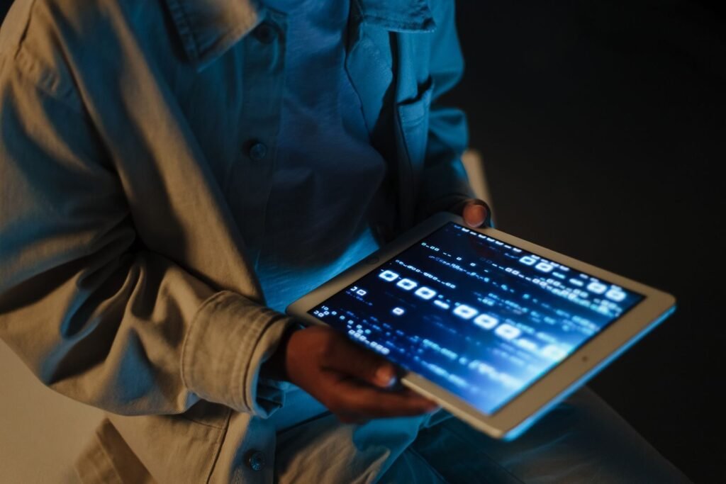Closeup of a person using a tablet device indoors with code visible o | edCircuit Close up of a person using a tablet device indoors with code visible o