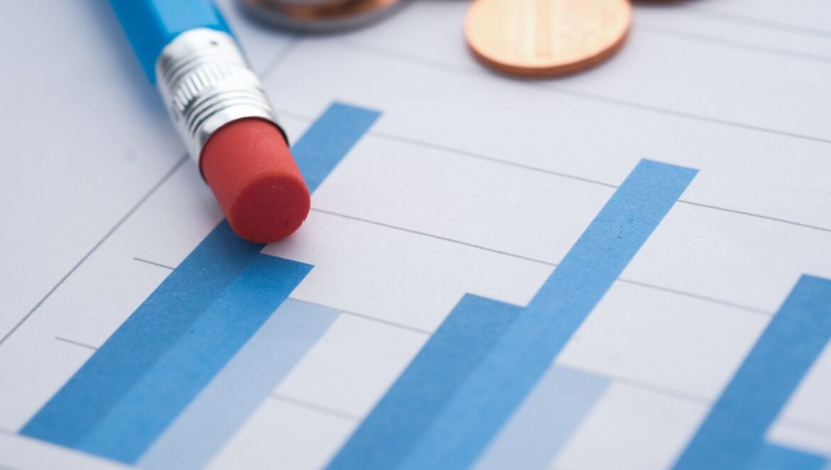 Closeup of bar graphs with a pencil and coins symbolizing financial | edCircuit Close up of bar graphs with a pencil and coins symbolizing financial