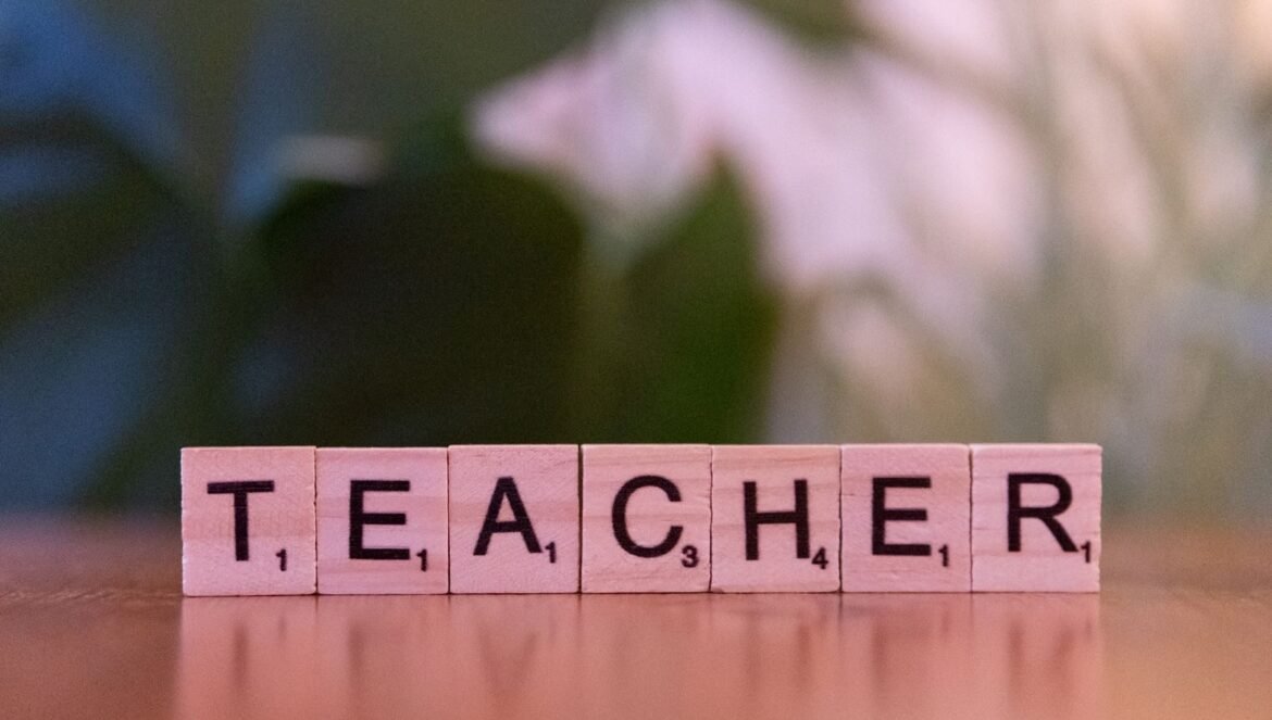 Closeup of wooden tiles spelling Teacher on a table conveying educ | edCircuit Close up of wooden tiles spelling Teacher on a table conveying educ