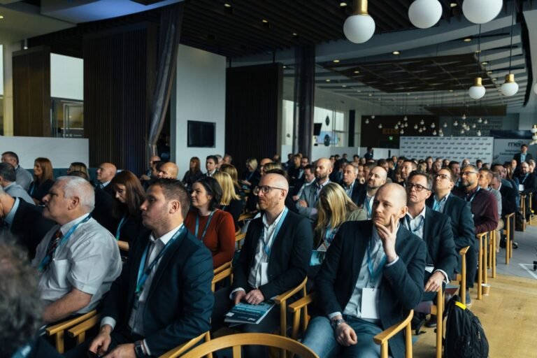 Business professionals listening at an indoor conference