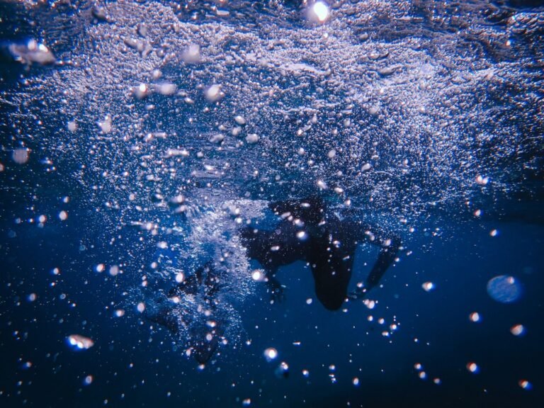 Dramatic underwater shot capturing dynamic bubbles and silhouette of a diver
