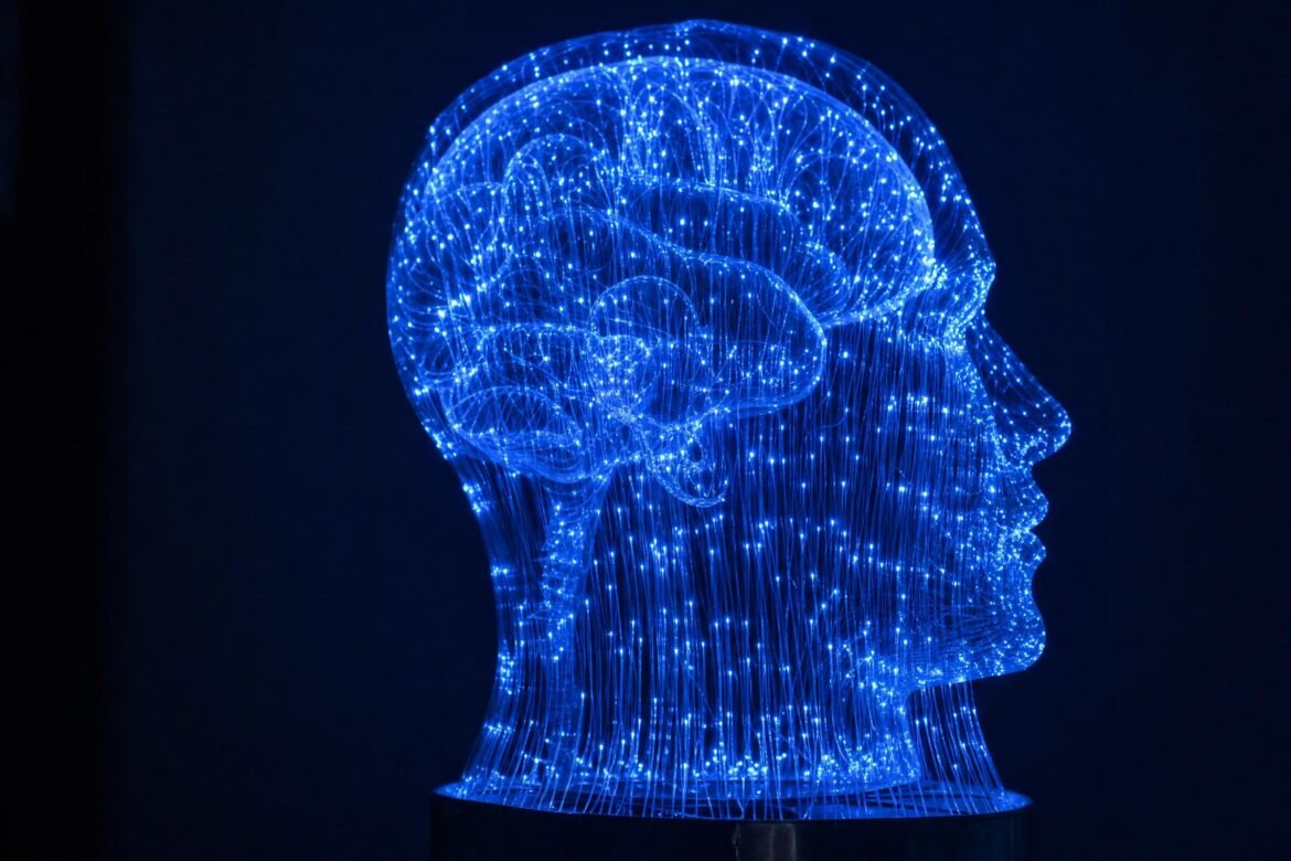 A glowing blue fiber-optic sculpture shaped like a human head and brain, made of connected points of light, against a dark navy background