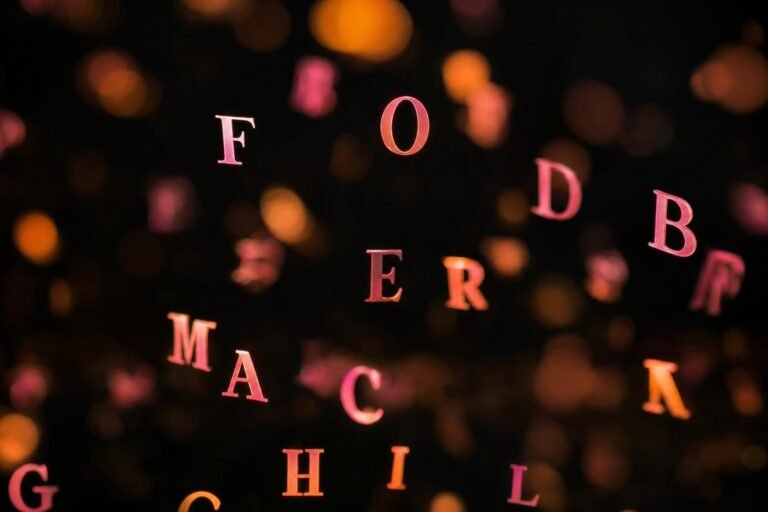 Glowing pink and orange alphabet letters floating and blurred in a dark space with soft bokeh lights, abstract dreamy mood