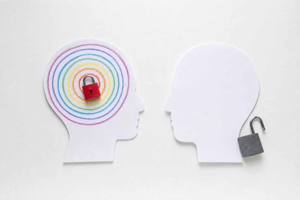 Two paper cutout head silhouettes in profile one with colorful rings drawn inside and a small red padlock a gray padlock hanging beside the other white backg | edCircuit Two paper cutout head silhouettes in profile one with colorful rings drawn inside and a small red padlock a gray padlock hanging beside the other white backg