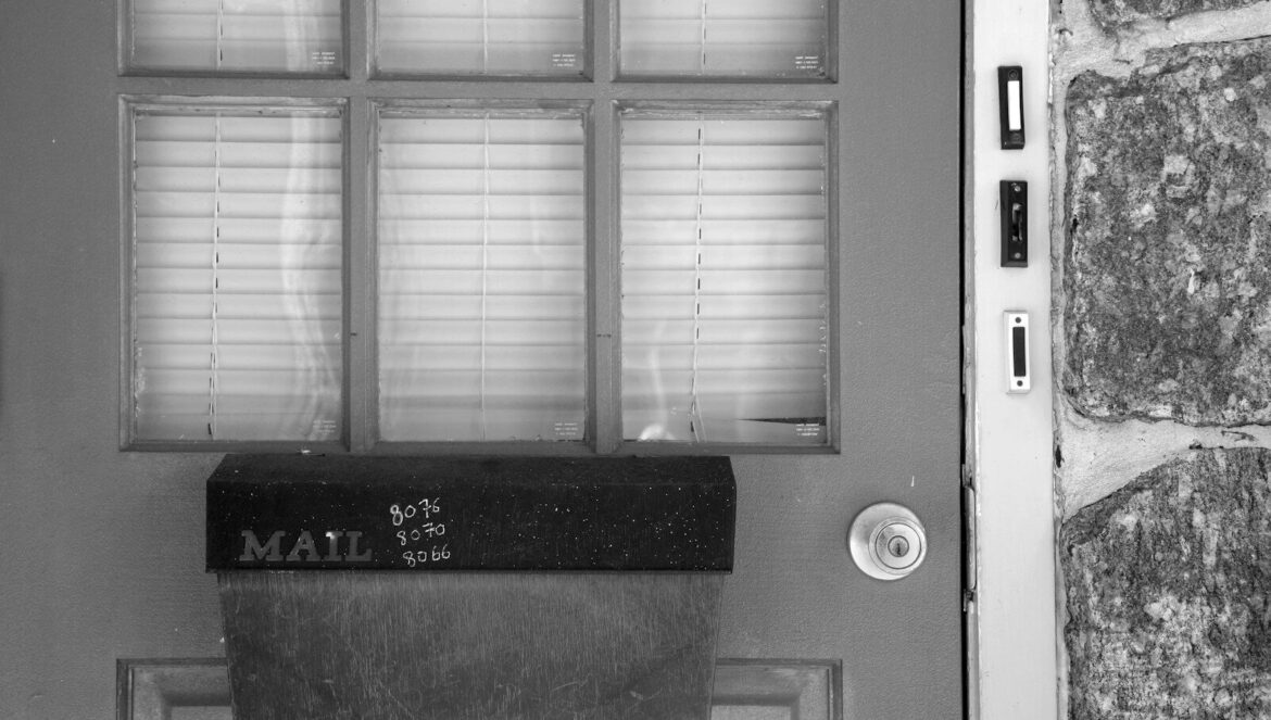 Mailbox attached to a door with glass panes