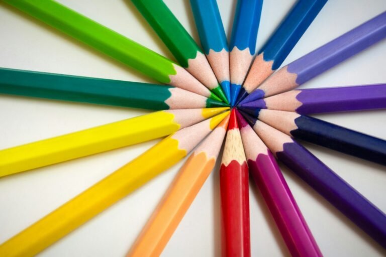 Multi colored pencils on white surface