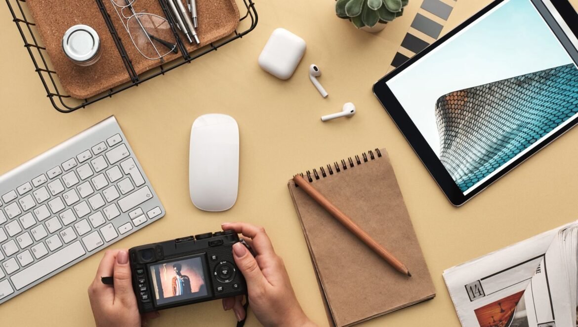 Overhead view of a modern workspace featuring tech gadgets a camera