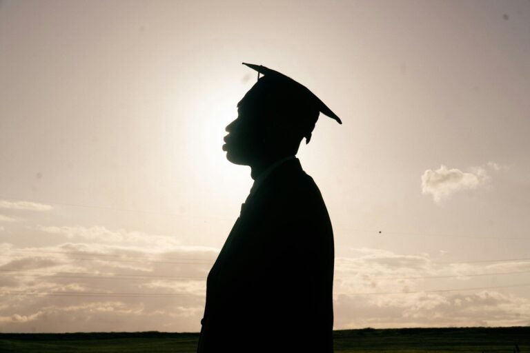 Silhouette of a graduate in a cap and gown